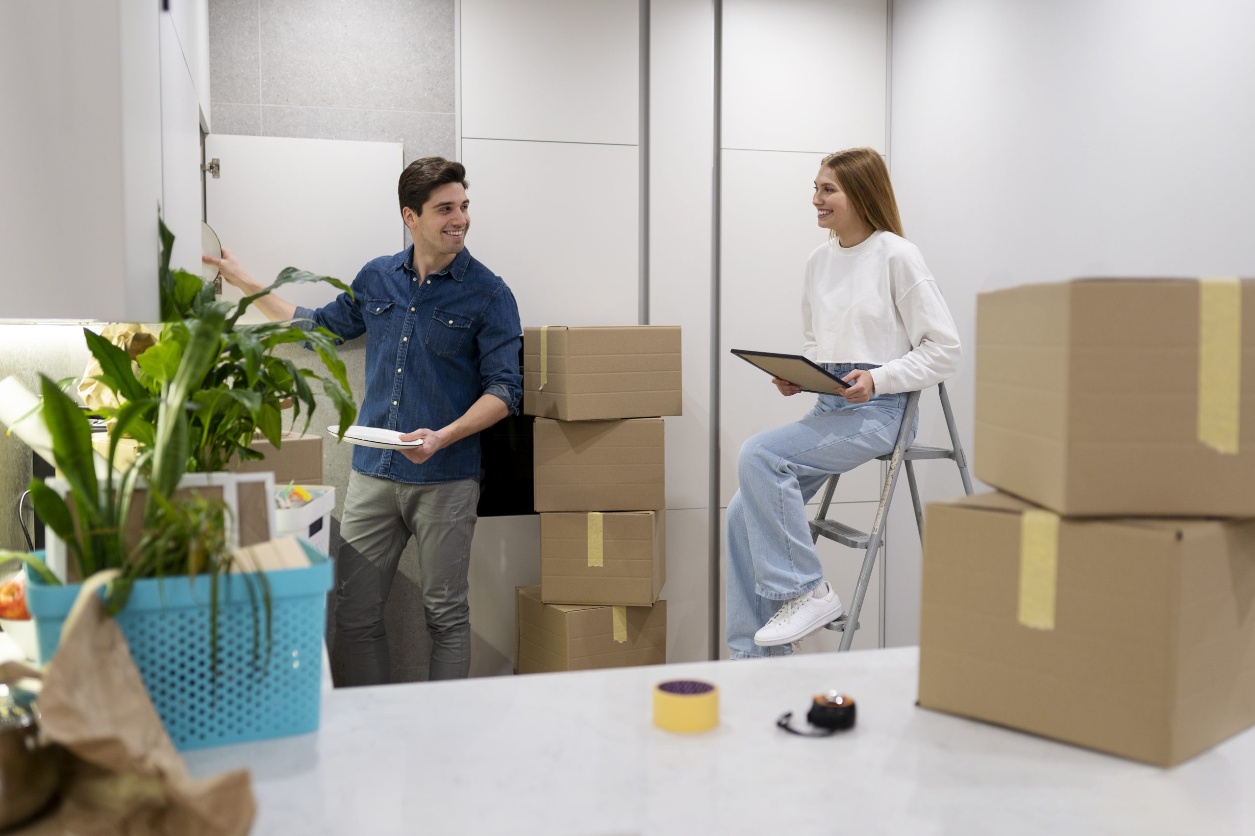 couple-unpacking-their-belongings (1) Professional mover from Harry the Mover delivering boxes to a happy family, showcasing their residential moving services.