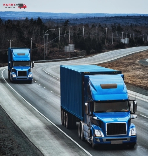 Blue moving trucks on highway showing cost-effective move from Melbourne to Canberra.
